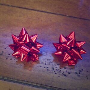 Mini actual holiday bow earrings in metallic red,